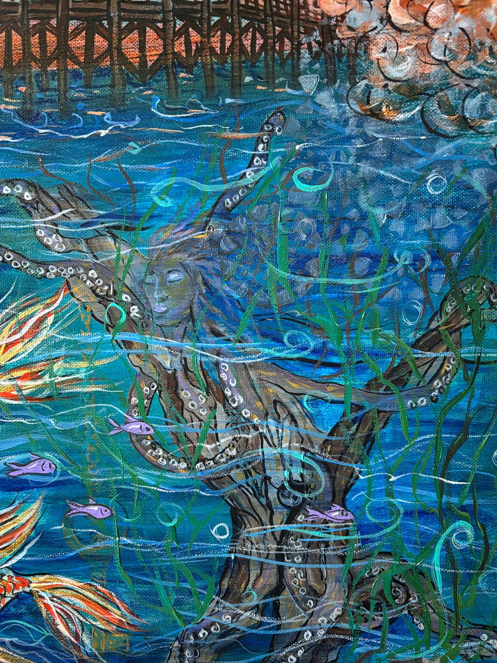 Close-up detail of an octopus beneath the Cocoa Beach Pier among blue water, seaweed, and small fish in Not all Journeys seek a Shore