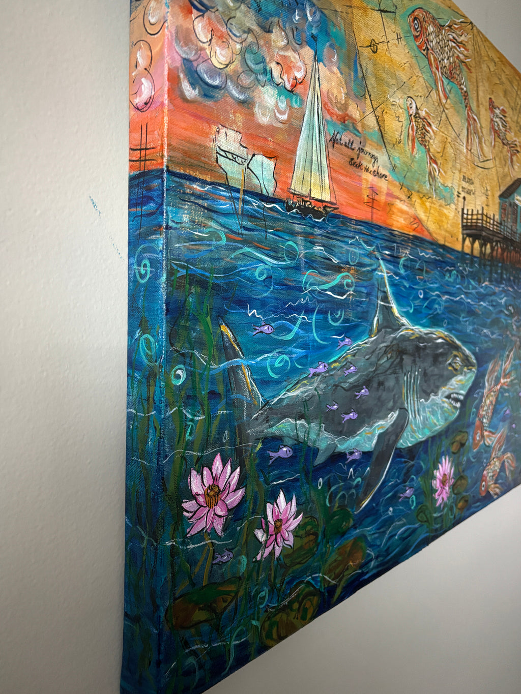 Angled sideview of Not all Journeys Seek a Sore showing the painted canvas edge with a shark, koi, sailboat and water Lillies