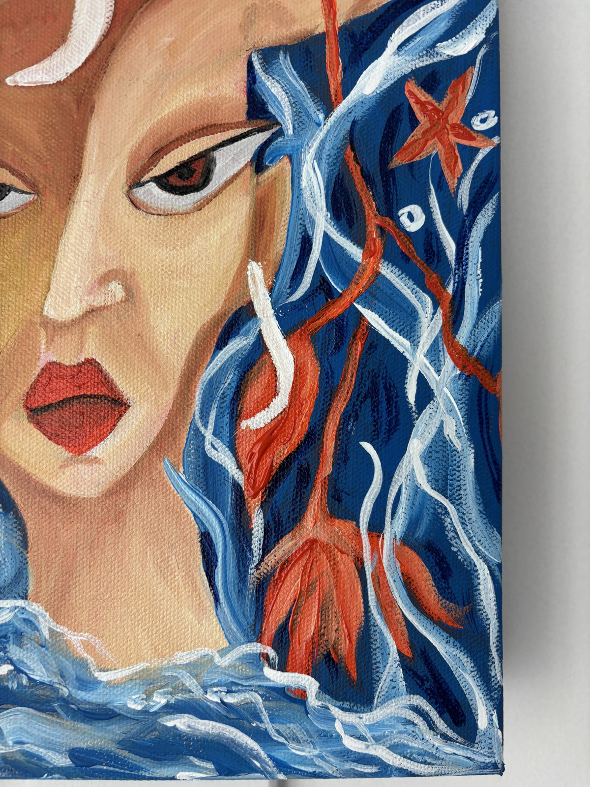 Detail of Bloom Beneath the Tide showing the red flower and a starfish in blue hair